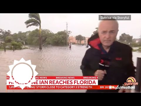 Cameraman helps people escape Hurricane Ian flooding during live coverage | AccuWeather