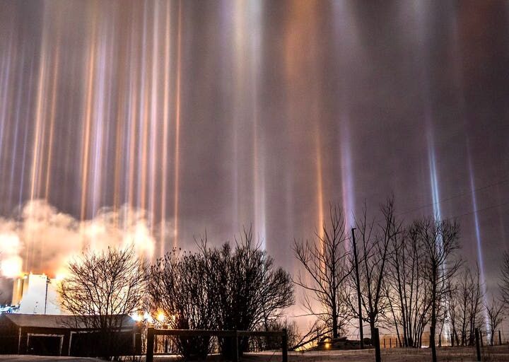 Light pillars illuminate night sky over Canada