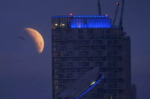 Stunning pictures show partial lunar eclipse today over London skyline